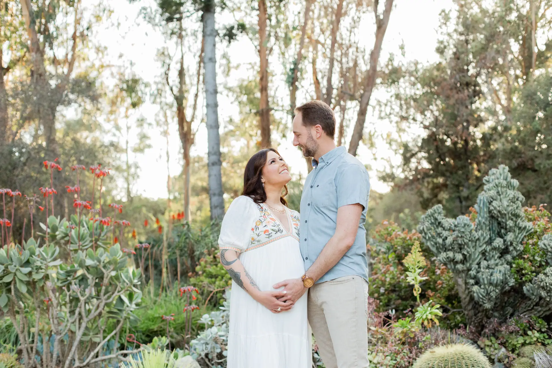 Married pregnant couple posed in a cactus garden. Photos by Shannon Alyse photography
