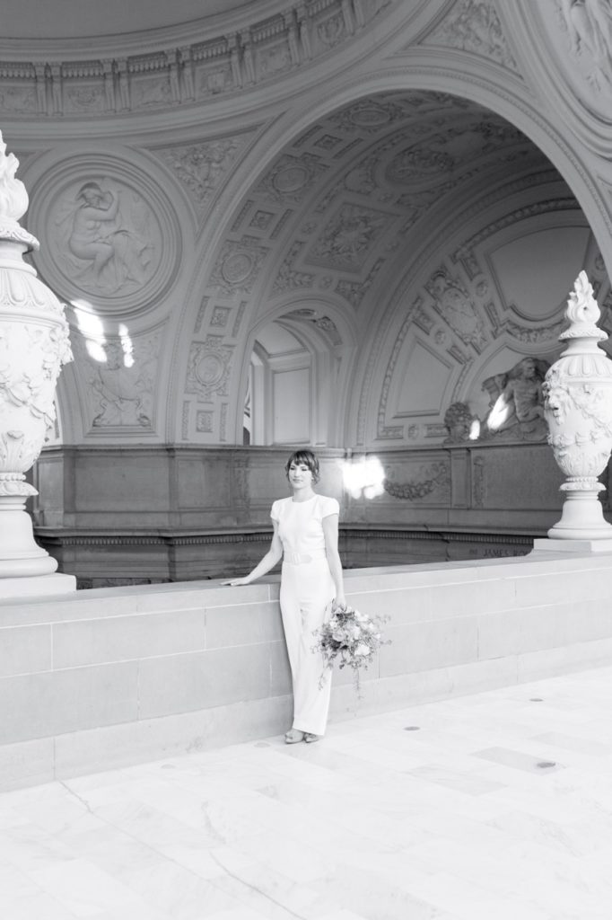 Bride standing with bouquet in black and white