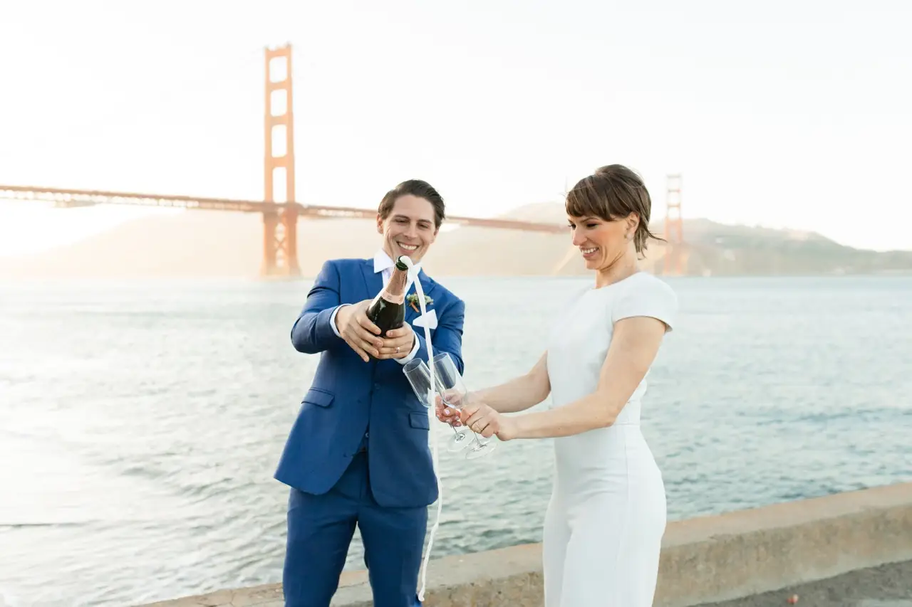 Married couple celebrating with champagne on the beach