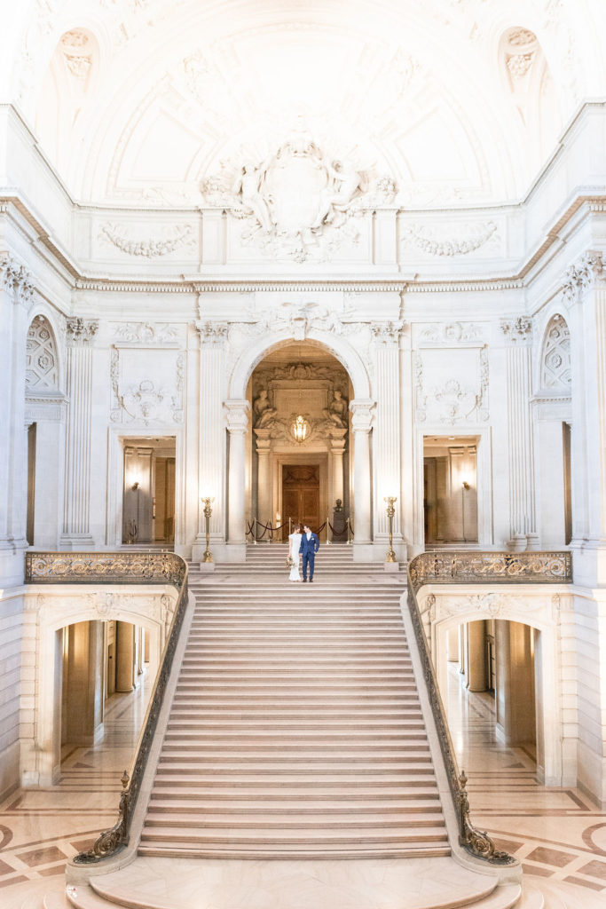 Bride and groom standing at the grand staircase in San Francisco court house. Photos by Shannon Alyse Photography