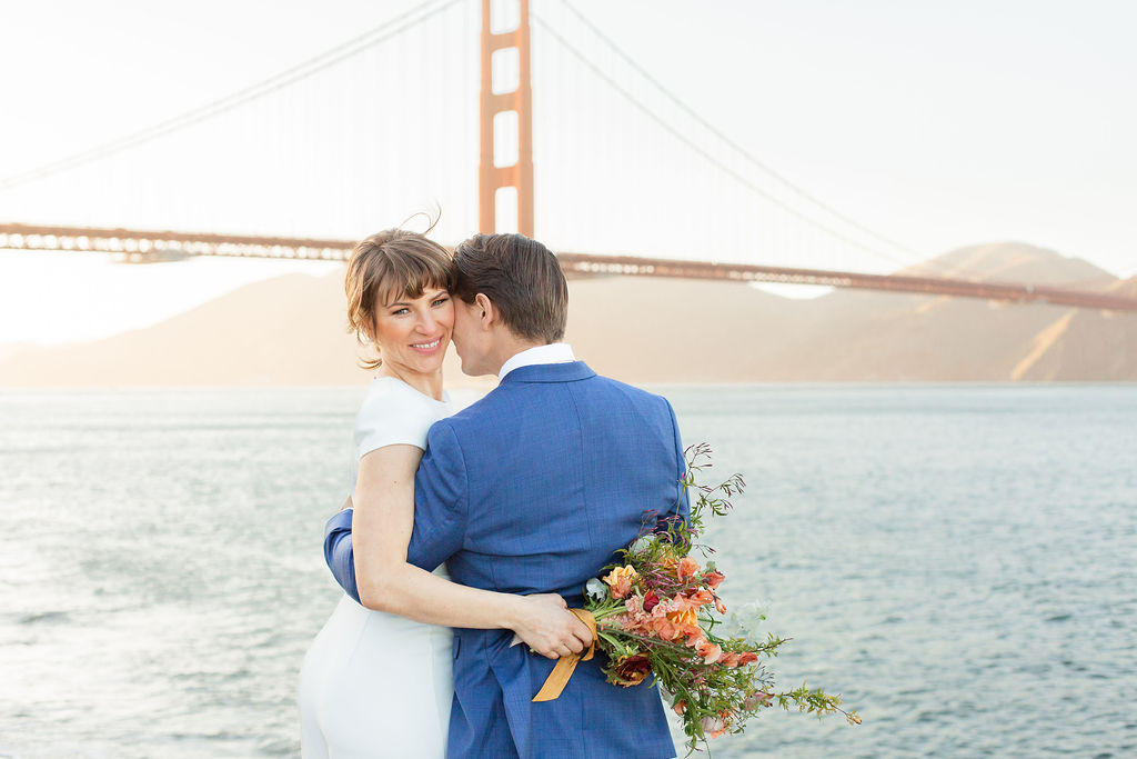 Bride and groom standing in front of San Francisco's Golden Gate Bridge. Photos by Shannon Alyse Photography