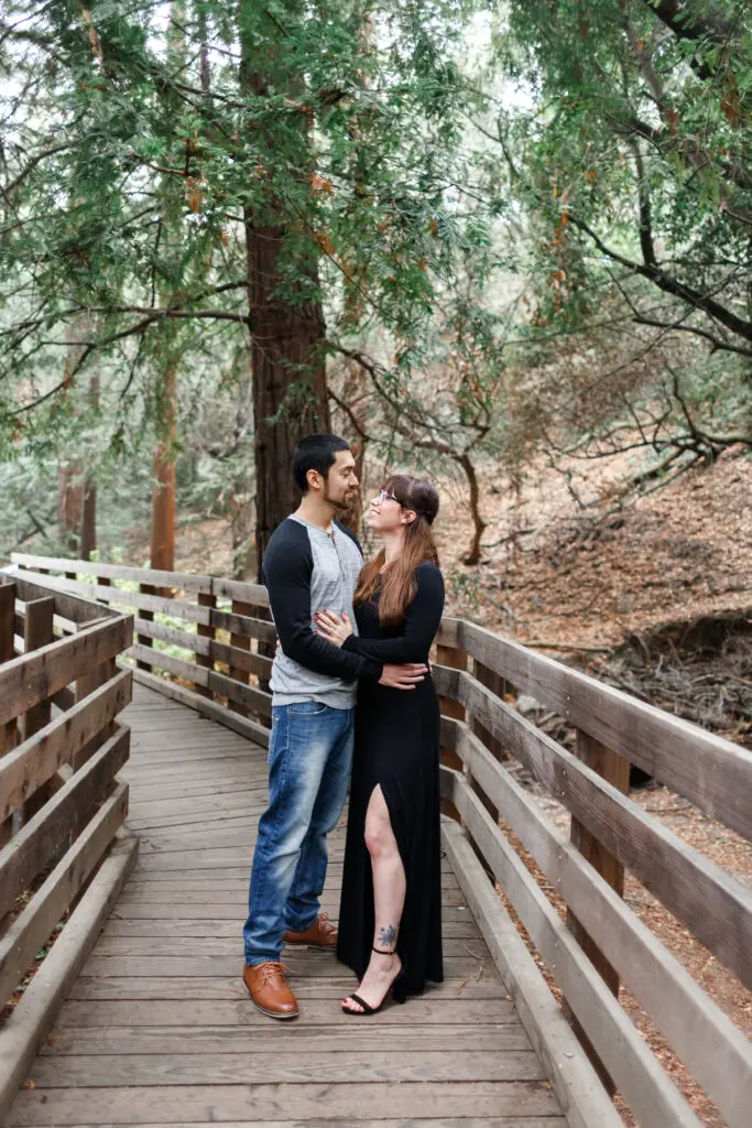 Playful couple in a redwood forest.
