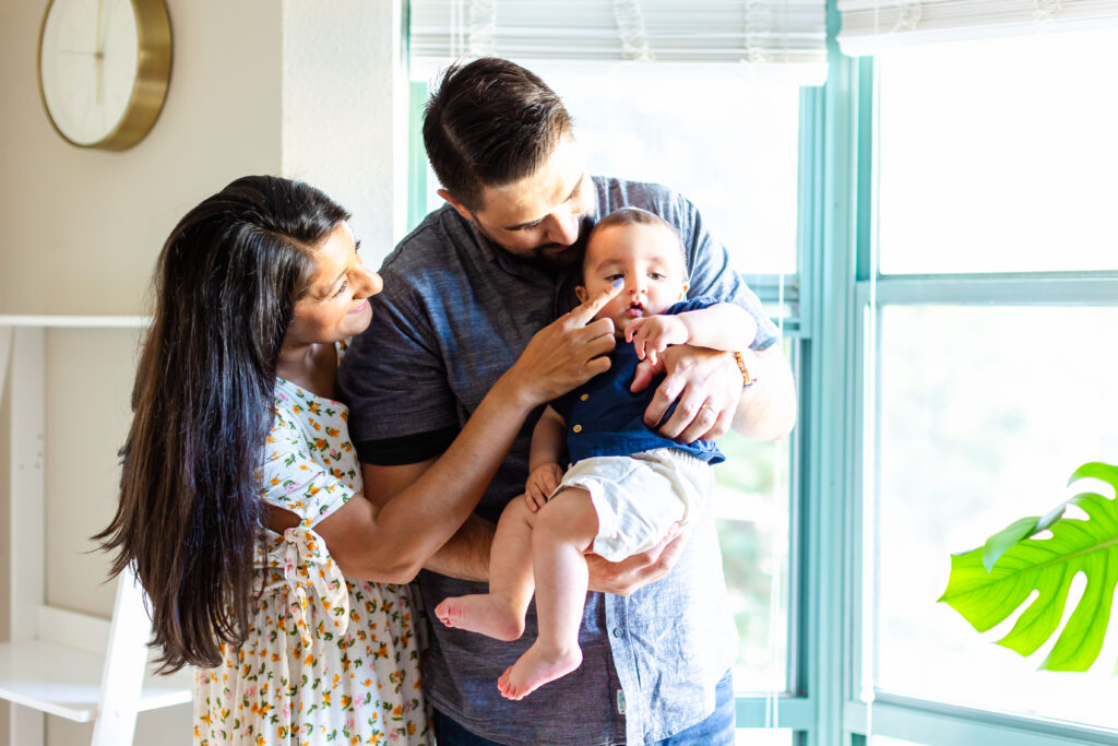 Samita, Scott, and baby Paul sharing a heartfelt embrace in their cherished apartment.